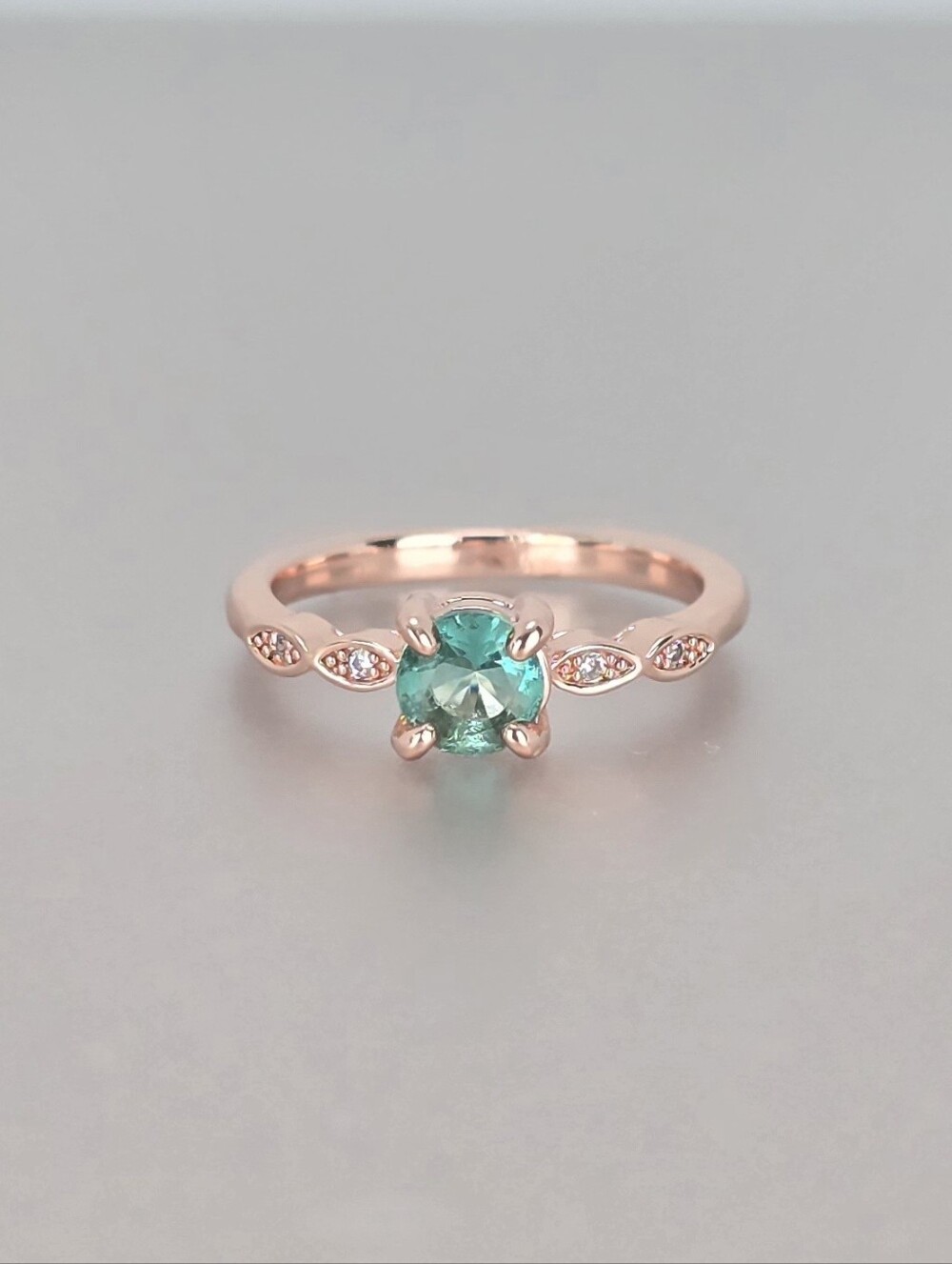 Rose Gold Ring with Green Center Stone and Leaf Accent Gems
